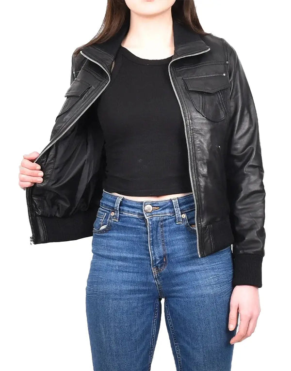 Person wearing a black leather jacket and blue jeans on a white background