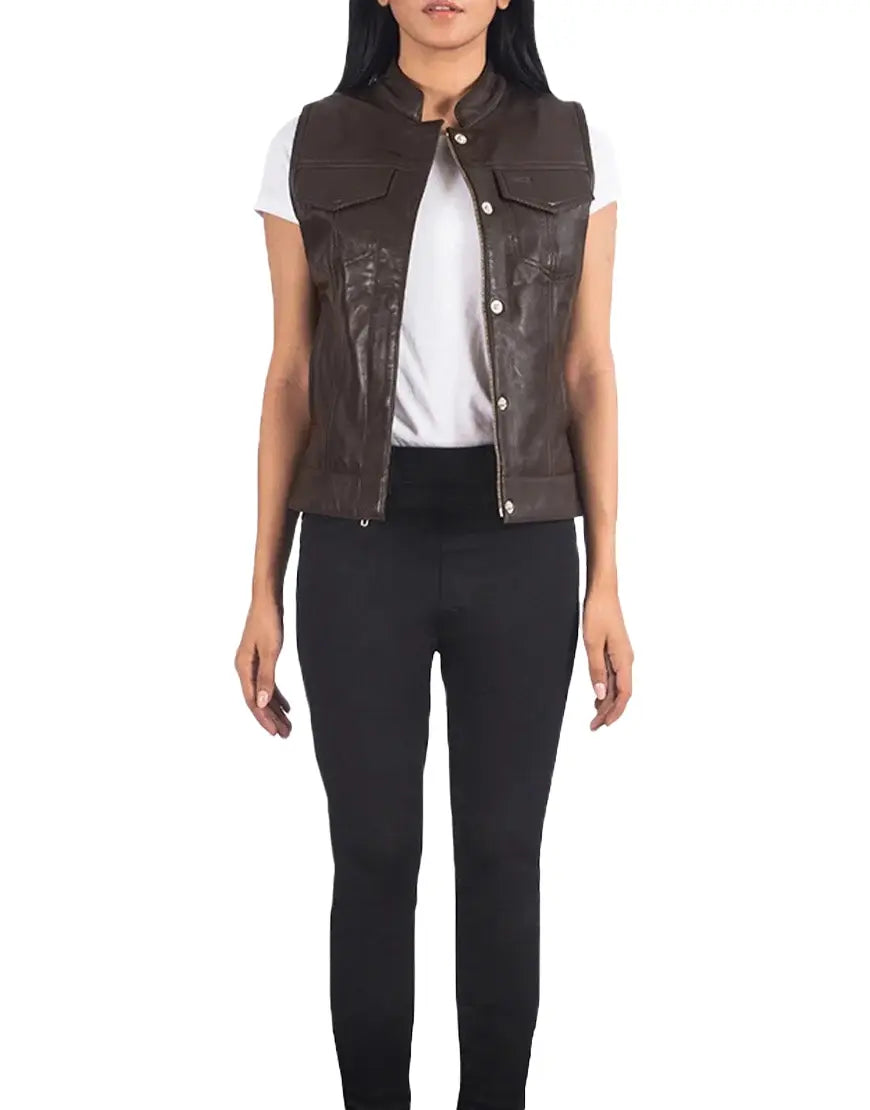 Woman wearing a brown leather vest over a white shirt and black pants on a white background